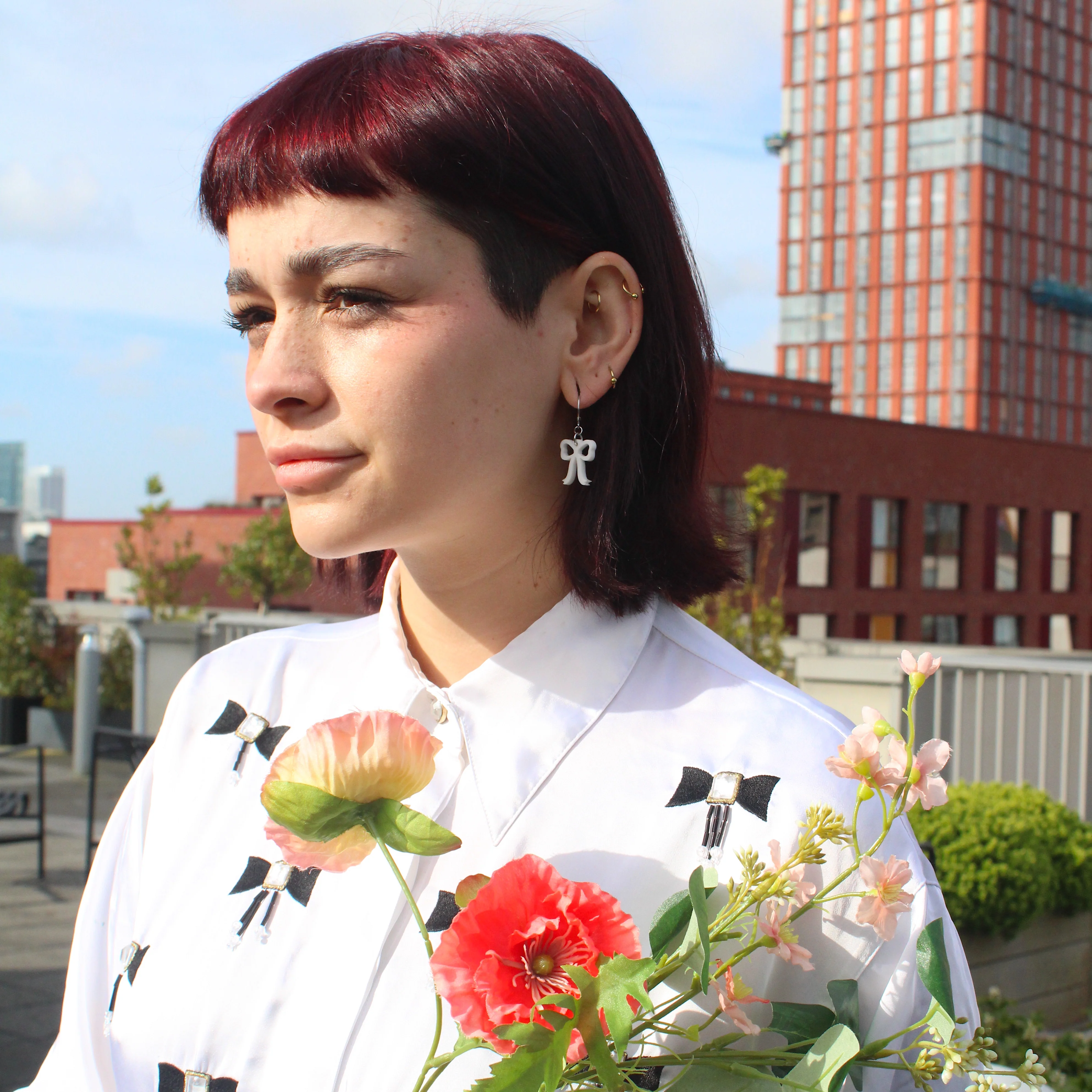Mini White Bow Huggie Hoop Earrings - Image 4