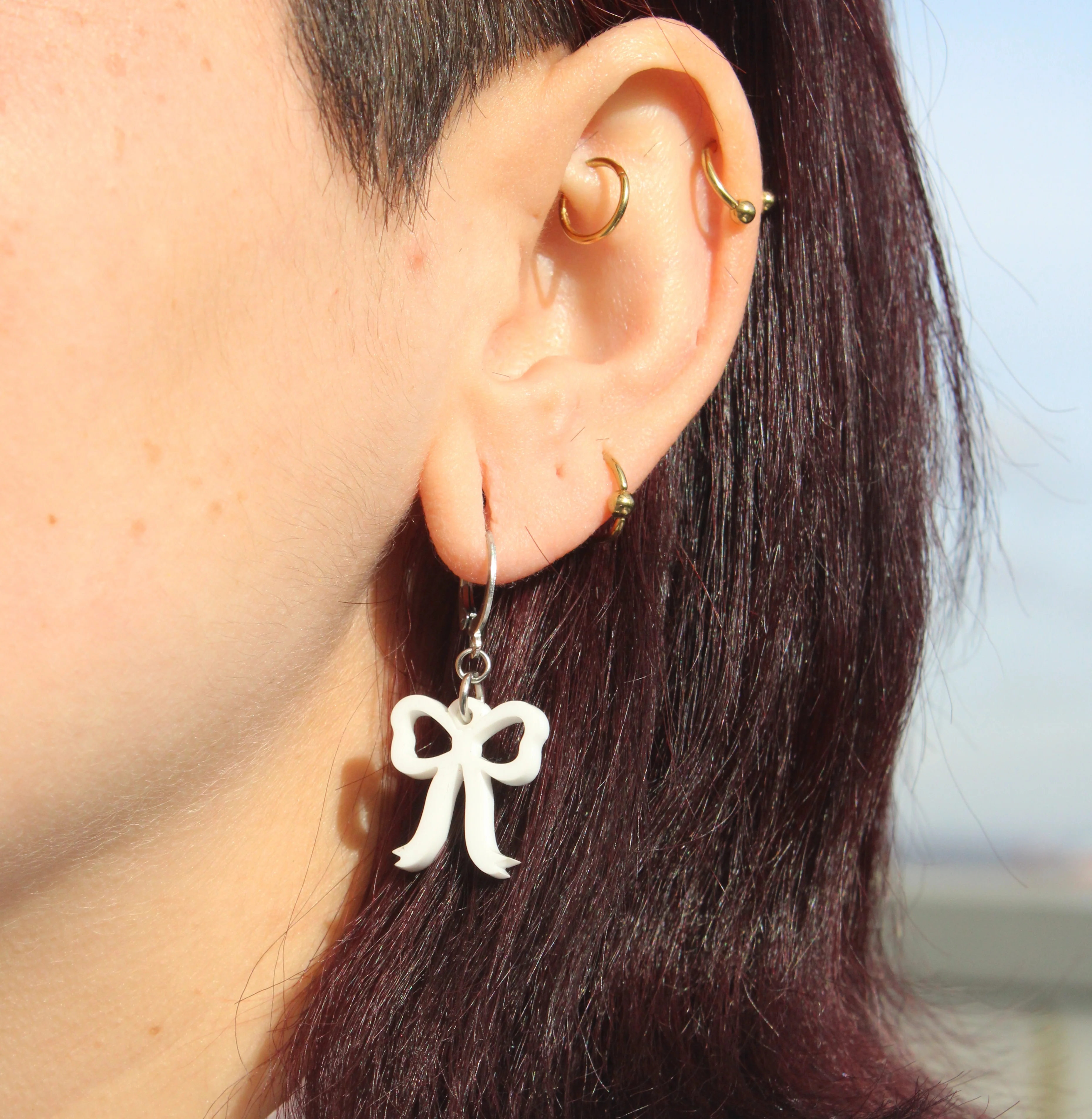 Mini White Bow Huggie Hoop Earrings - Image 5